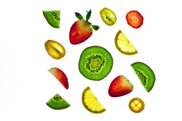 Sliced fruit on a white background. Kiwi, strawberry, lemon and kumquat.