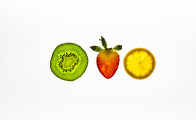 Sliced fruit on a white background. Kiwi, strawberry and lemon.