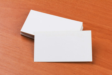 white blank business cards on wooden background.close-up