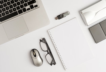 Office desk or executive desk with laptop, white sheet book, glasses, external hard drive in black...