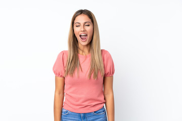 Fototapeta premium Young blonde woman over isolated white background shouting to the front with mouth wide open