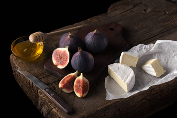Fresh ripe figs. Breakfast with figs, cheese, honey and nuts. A few figs on an old wooden...