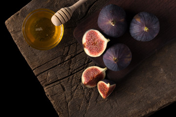 Fresh ripe figs. Breakfast with figs, cheese, honey and nuts. A few figs on an old wooden...
