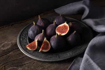 Fresh ripe figs. Breakfast with figs, cheese, honey and nuts. A few figs on an old wooden...
