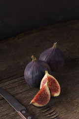 Fresh ripe figs. Breakfast with figs, cheese, honey and nuts. A few figs on an old wooden...