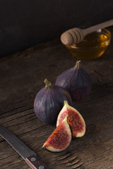 Fresh ripe figs. Breakfast with figs, cheese, honey and nuts. A few figs on an old wooden...