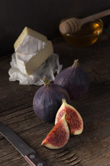 Fresh ripe figs. Breakfast with figs, cheese, honey and nuts. A few figs on an old wooden...