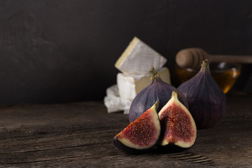 Fresh ripe figs. Breakfast with figs, cheese, honey and nuts. A few figs on an old wooden...