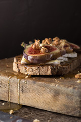 Figs. Sandwiches with figs, cheese, arugula, honey and nuts. toast with creamy yogurt and feta cheese spread, fresh figs with honey. Bruschetta with cheese and figs. Homemade. Everyday autumn kitchen.