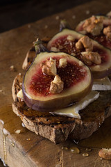 Figs. Sandwiches with figs, cheese, arugula, honey and nuts. toast with creamy yogurt and feta cheese spread, fresh figs with honey. Bruschetta with cheese and figs. Homemade. Everyday autumn kitchen.
