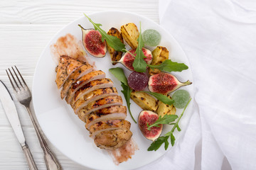 Baked chicken with fig and arugula salad. Chicken breast, fig, arugula. Dinner. Fried chicken breast with vegetables and figs. Dish with figs. fried chicken with figs and onions. Free space for text. 
