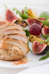 Baked chicken with fig and arugula salad. Chicken breast, fig, arugula. Dinner. Fried chicken breast with vegetables and figs. Dish with figs. fried chicken with figs and onions. Free space for text. 
