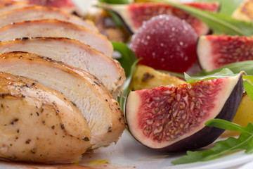 Baked chicken with fig and arugula salad. Chicken breast, fig, arugula. Dinner. Fried chicken breast with vegetables and figs. Dish with figs. fried chicken with figs and onions. Free space for text. 