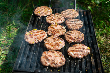 Summer barbecue. Fresh burgers on grill