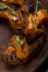 Chicken baked with pumpkin. Baked chicken with pumpkin. Roasted pumpkin and meat. Chicken pieces on a cushion of vegetables. Autumn dish. Everyday autumn kitchen. Orange colors. 