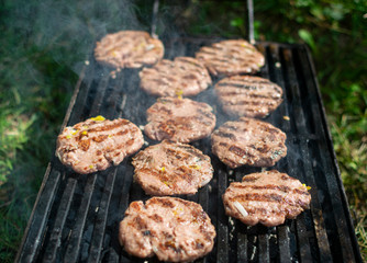 Summer barbecue. Fresh burgers on grill