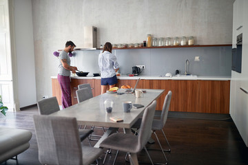 young couple enjoying together in kitchen while preparing food. lifestyle, modern, casual living concept