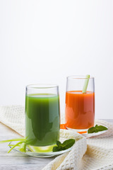 Fresh vegetables smoothie carrots, celery and greens with mint. On a light background