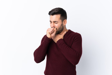 Young handsome man with beard over isolated white background is suffering with cough and feeling bad