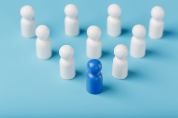 The leader in blue leads a group of white employees to victory, HR, Staff recruitment. The concept of leadership.