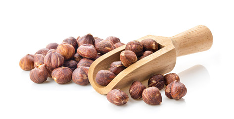hazelnuts in wood scoop  on white background