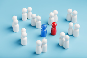 Choosing a sexual partner for love, relationships from such a crowd of monotonous people. A red woman and a blue man in a crowd of white people.