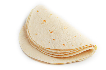 Tortilla on a white isolated background. Corn tortilla or simply tortilla is a type of thin unleavened bread made from Hominy.