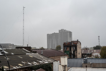 Avellaneda, Buenos Aires, Argentina; June 13, 2019: View of an abandoned building under construction (white elephant) covered in fog on top. In front you can see an urban image surrounding