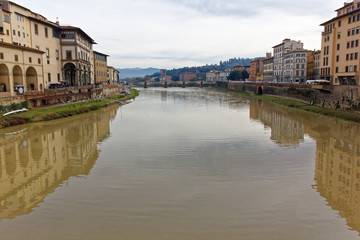Florence Firenze arno river Italy during winter season. Showing cloudy sky. both coast of the river can be seen on this image showing the amplitude of the river.