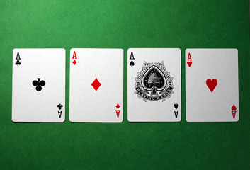 playing cards, four aces on a green background