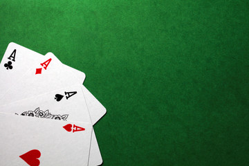 playing cards, four aces on a green background