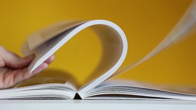 hand leafing through a book