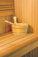 Obraz na płótnie Canvas Sauna interior room. Interior details Finnish sauna steam room with traditional sauna accessories basin scoop. Relax in hot sauna.
