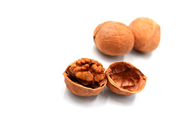 Peeled walnuts on a white indoor background