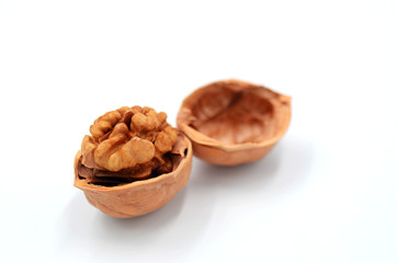 Peeled walnuts on a white indoor background