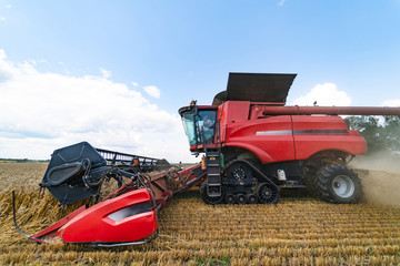 Combine harvester in action on the field. Combine harvester. Harvesting machine for harvesting a...
