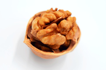 A peeled walnut on a white background