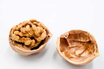 A peeled walnut on a white background