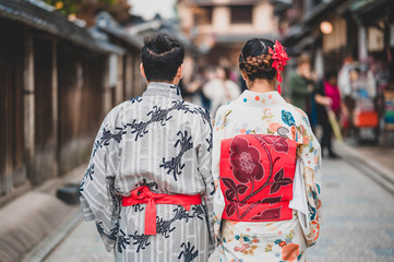 Fototapeta premium Young women wearing traditional Japanese Kimono with colorful maple trees in autumn is famous in autumn color leaves and cherry blossom in spring, Kyoto, Japan.