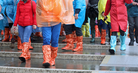 group of people with colored plastics leggings while raining