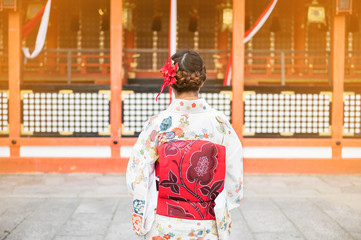 Young women wearing traditional Japanese Kimono  with colorful maple trees in autumn is famous in autumn color leaves and cherry blossom in spring, Kyoto, Japan.