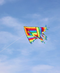 big kite with many colors on the blue sky