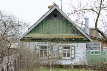 Carved platbands and shutters on the windows. Beautiful windows in old, abandoned houses.