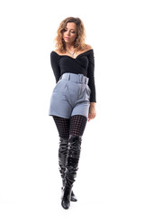 Beautiful feminine delicate elegant curly hair fashion woman with arms down looking down. Full body length isolated on white background.