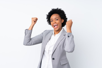 African american business woman over isolated white background celebrating a victory