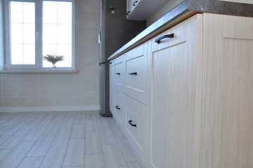 White window Doors of the kitchen cabinet. Kitchen worktop and fridge. Interior