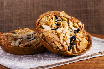 Homemade Almond cookies on wooden table background on napkin, Healthy cookies with prunes and almonds	