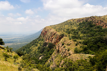 Fototapeta na wymiar Hikers on a ridge with Magaliesberg Mountain range in view