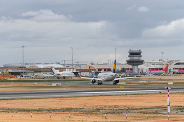 Fototapeta na wymiar Airport with passenger airplane landed