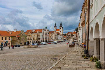 Telc / Czech Republic - September 27 2019: View of the historical city centre, UNESCO world heritage place, with arcades, houses and cobblestone street on a sunny day with blue cloudy sky.